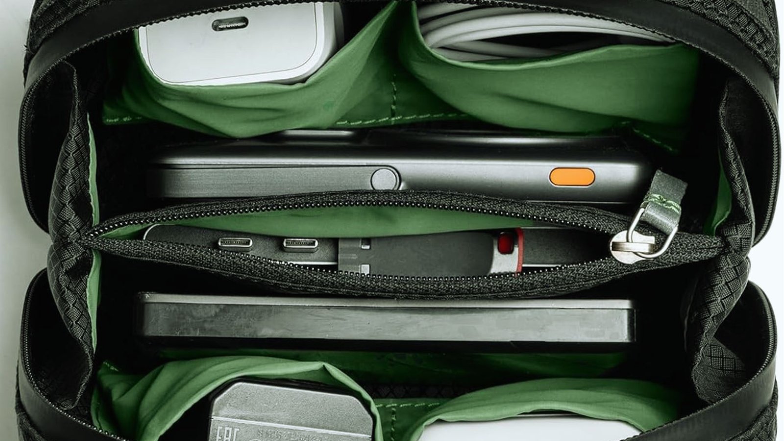  A backpack featuring a green zipper, showcasing a simple yet stylish design.
