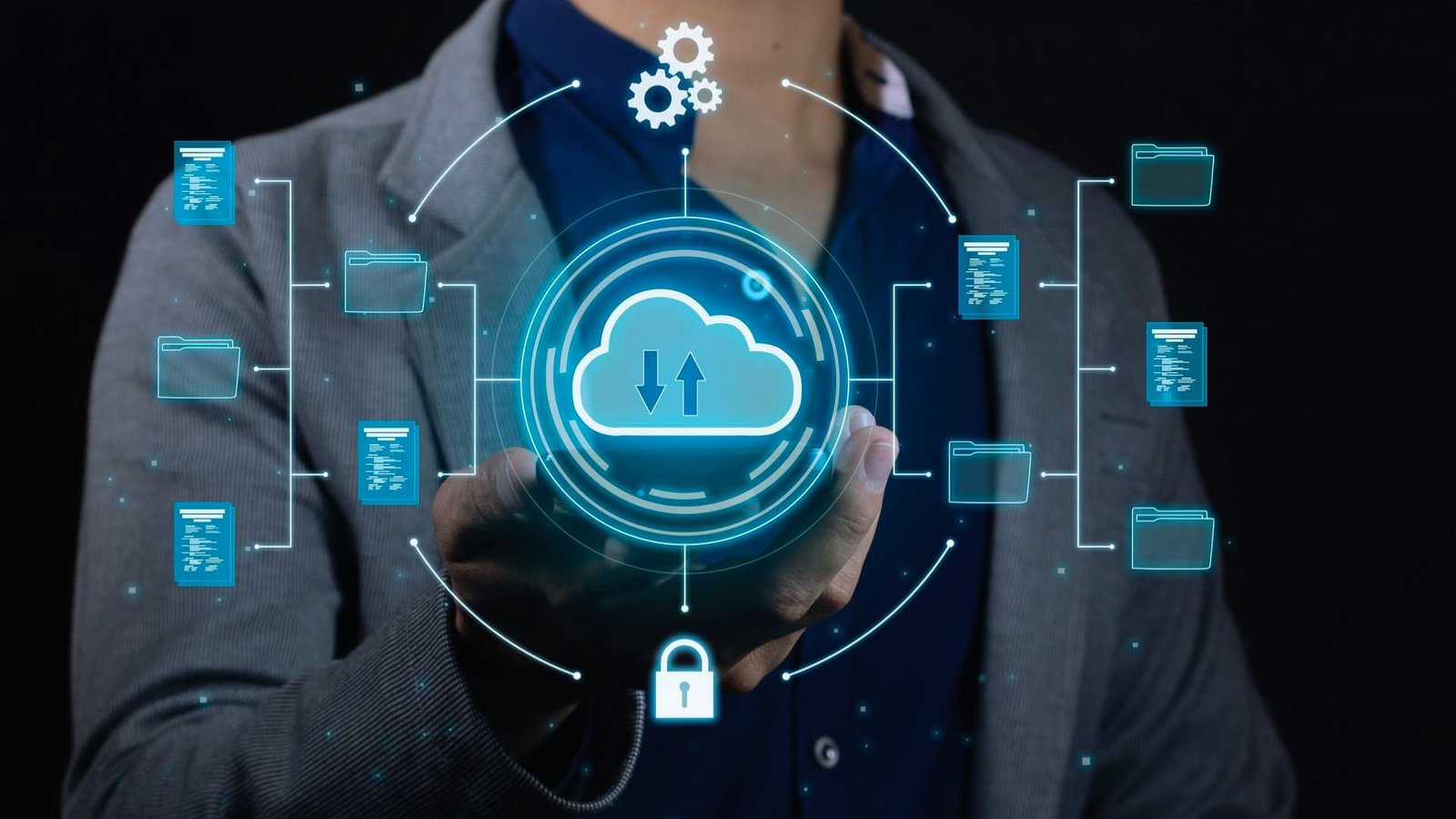  Man holding a cloud computing icon against a black background, symbolizing digital technology and data storage.