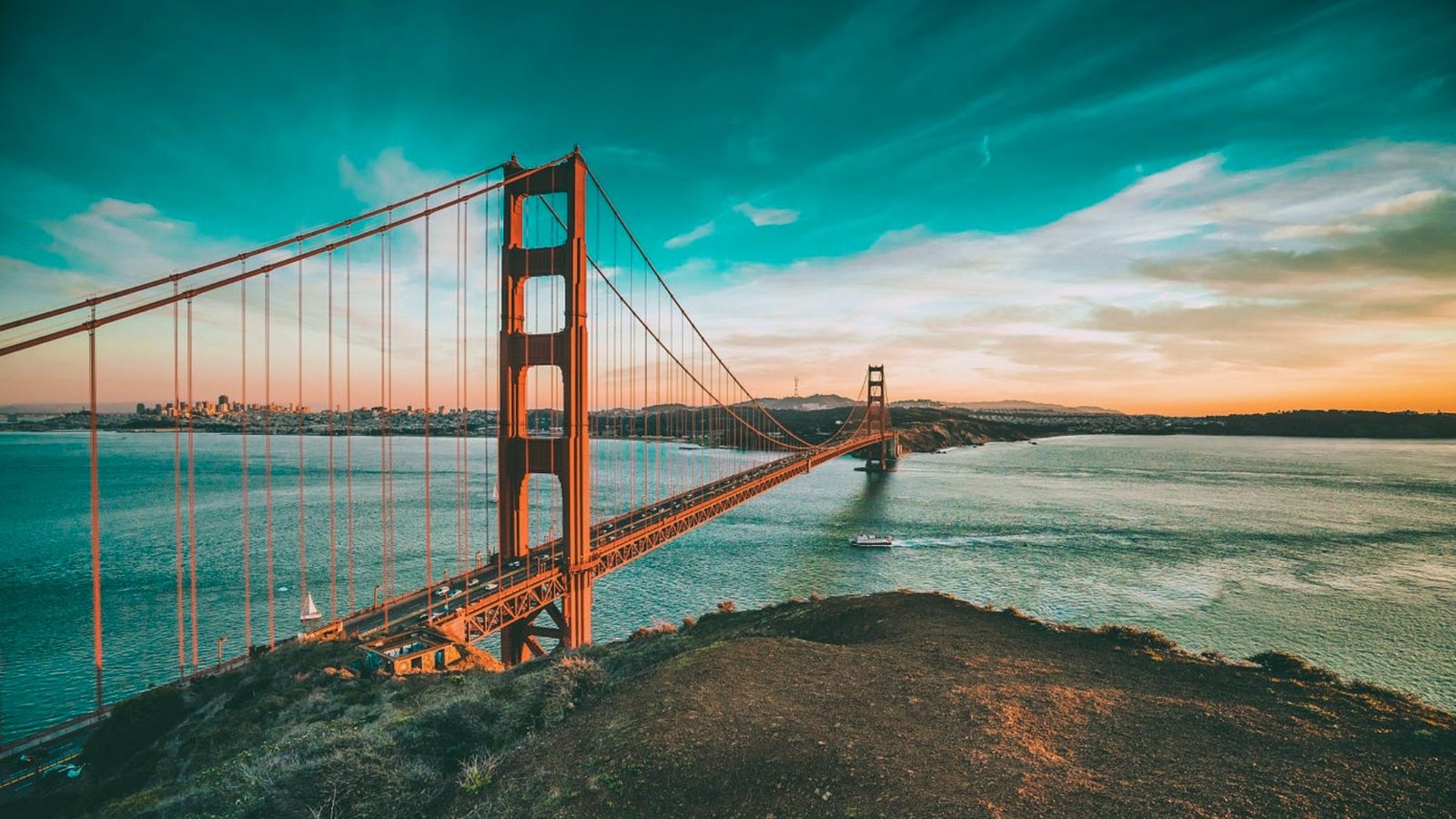 Golden Gate Bridge spanning the bay in San Francisco, California, with a clear blue sky in the background.