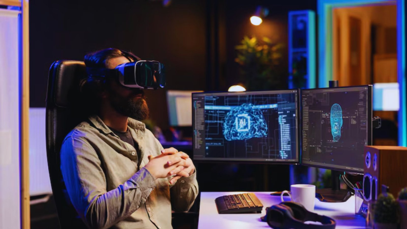 A man wearing a virtual reality headset stands in front of two computer monitors, engaged in an immersive experience.