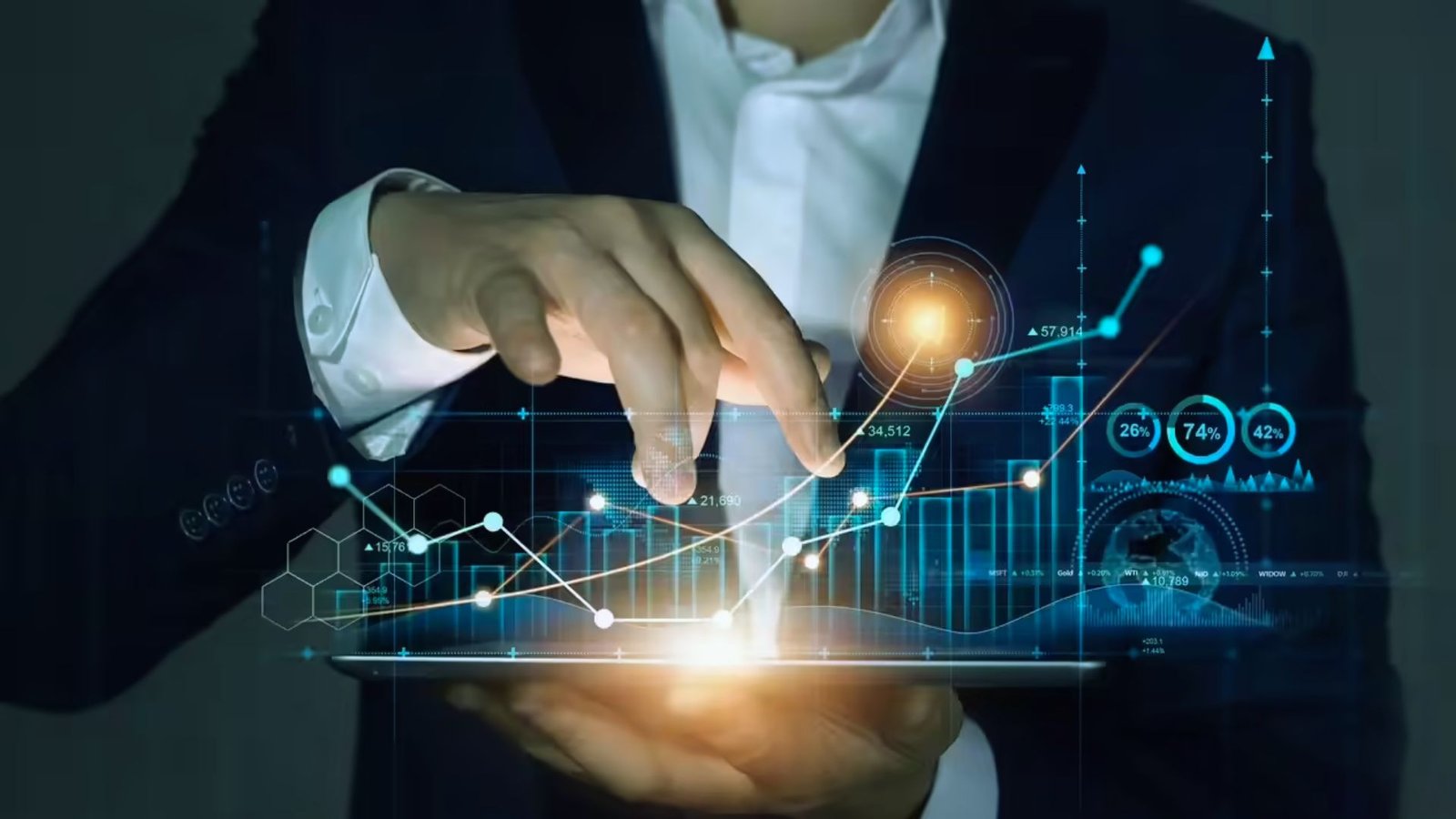  A man in a suit holds a tablet displaying a graph, indicating data analysis or business performance.
