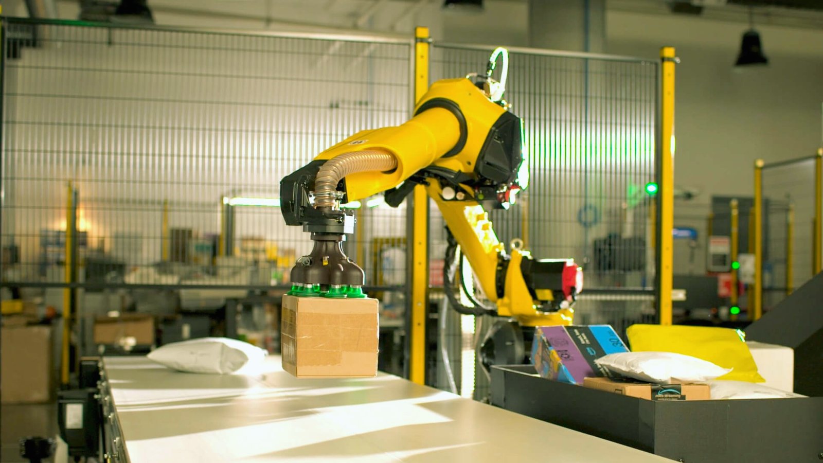 A robot operates a machine in a factory setting, showcasing automation in industrial work.