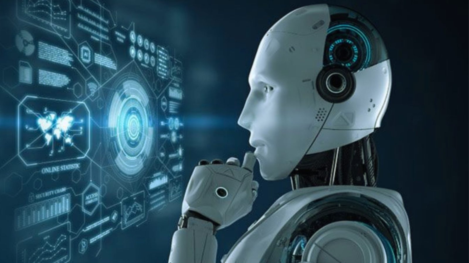 A robot gazes at a computer screen displaying various icons, showcasing its interaction with technology.
