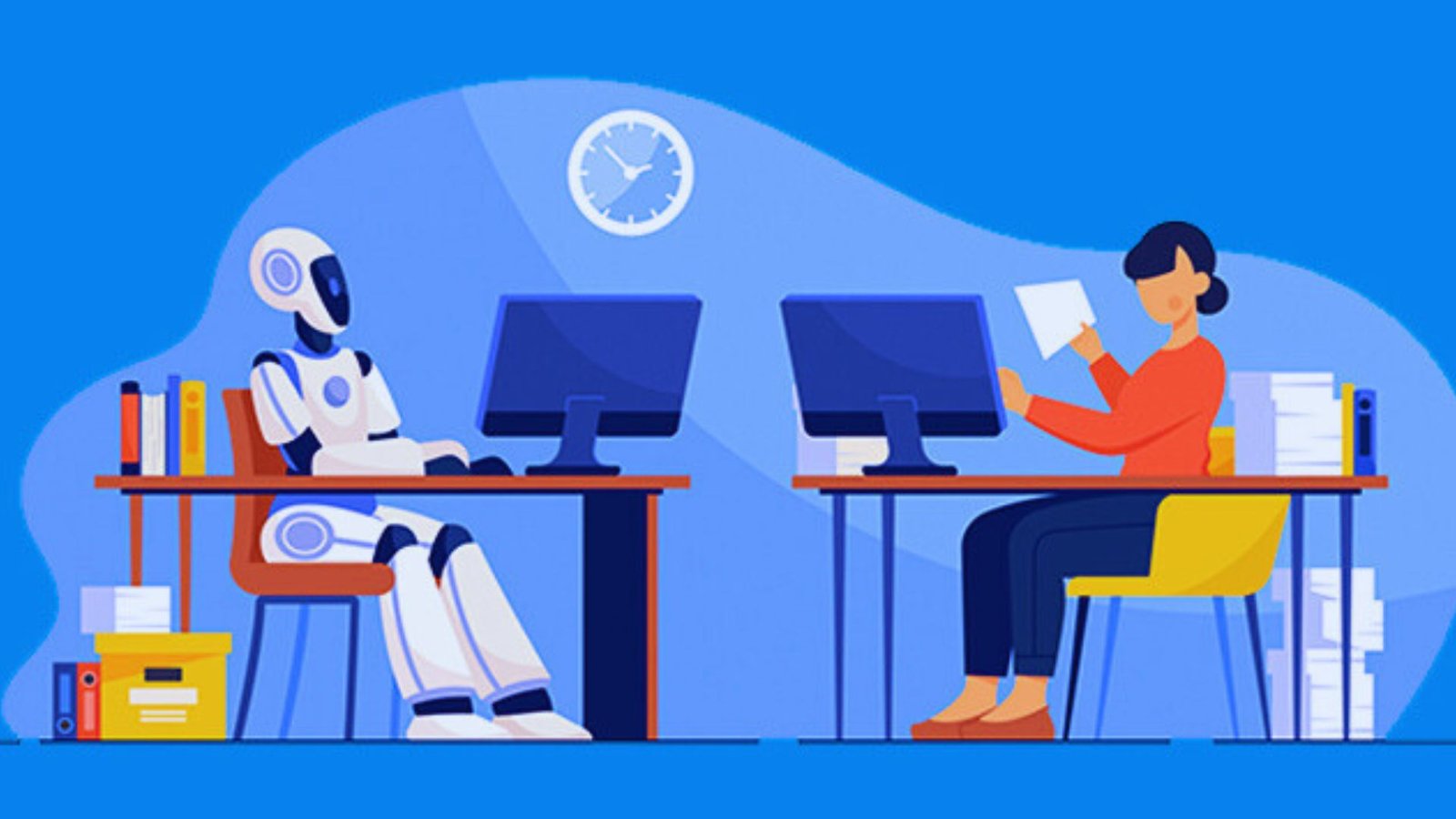 Two individuals seated at desks with computers, accompanied by a small robot on the table between them.