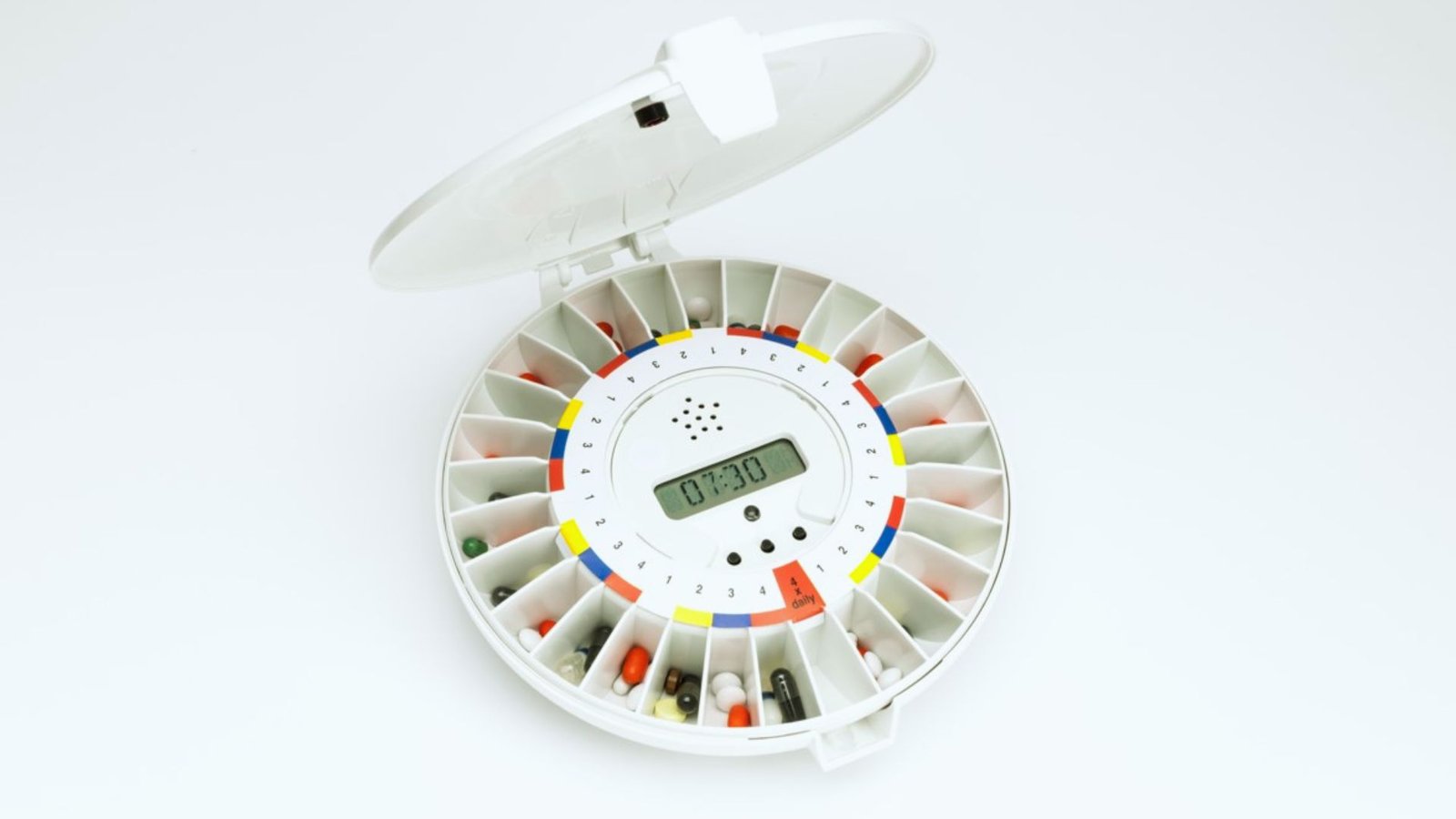  A pill dispenser featuring a digital clock on top for easy medication management and time tracking.
