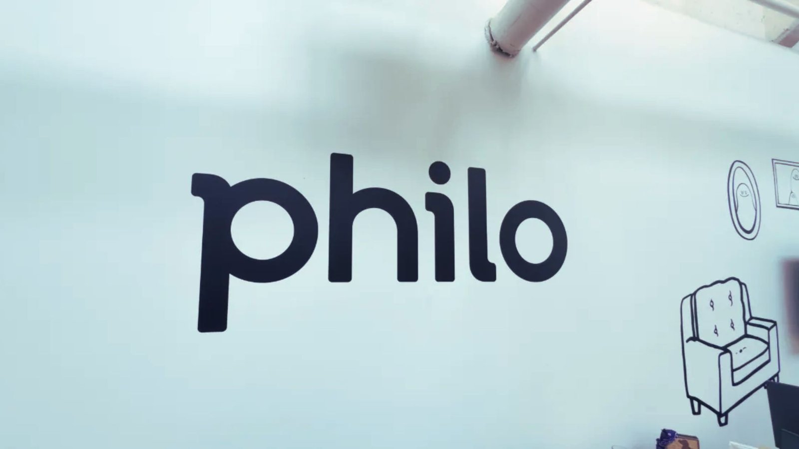 A white wall featuring the word "philo" prominently displayed in a bold font.
