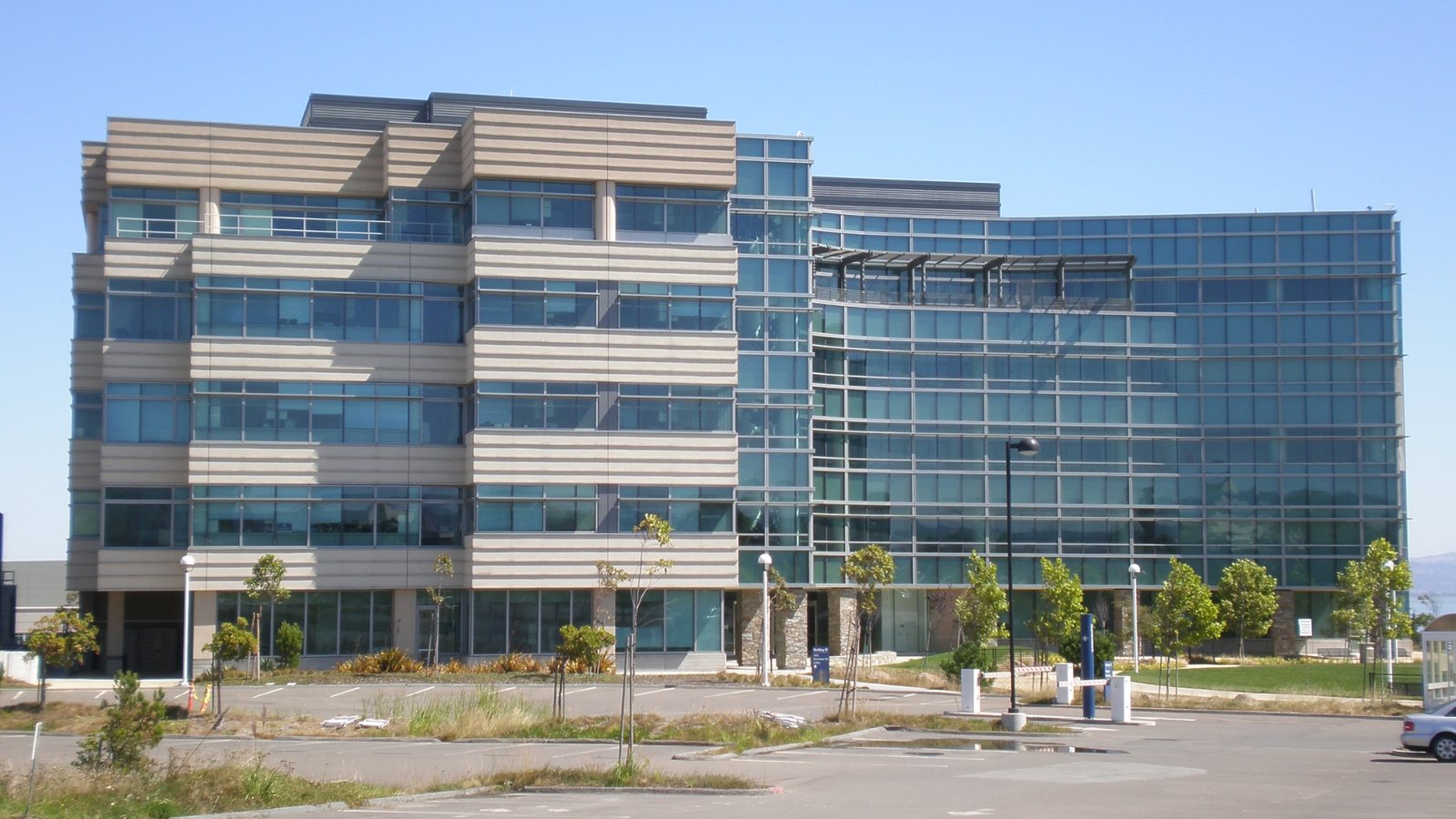 A large building featuring numerous windows, showcasing a modern architectural design.