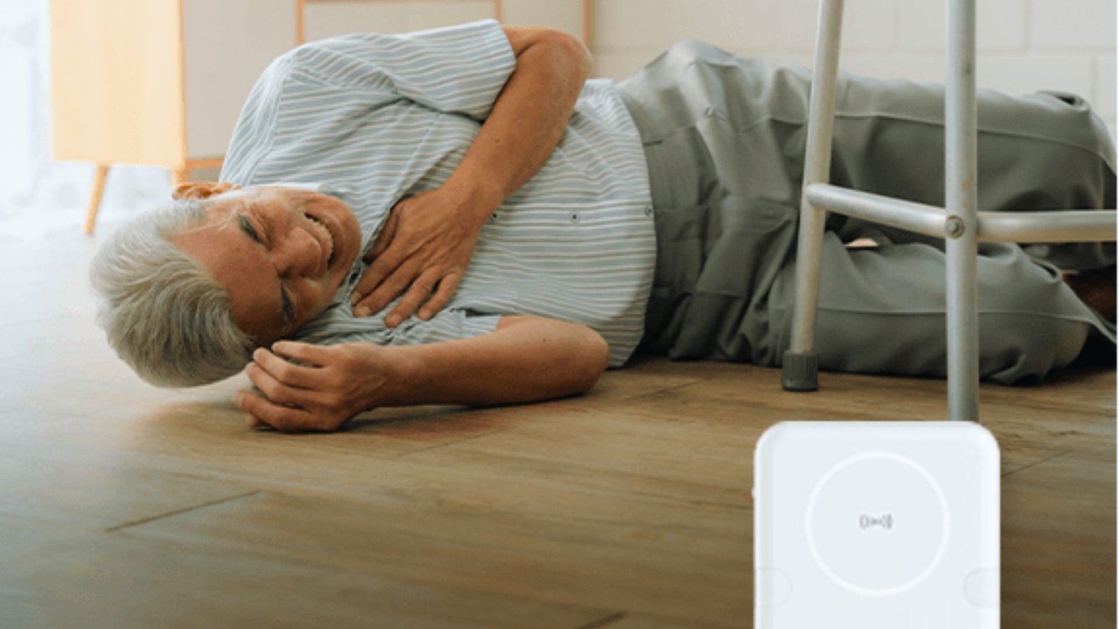 A woman lies on the floor beside a smart device, appearing relaxed and engaged with her surroundings.