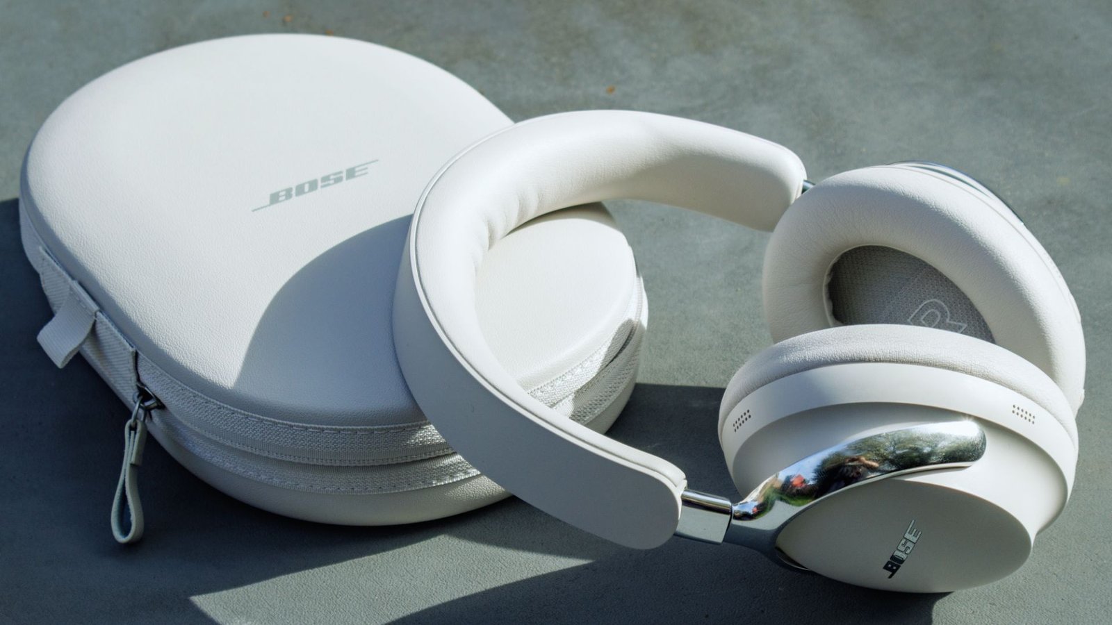 . Bose headphones displayed on a wooden table, showcasing their sleek design and modern aesthetic.