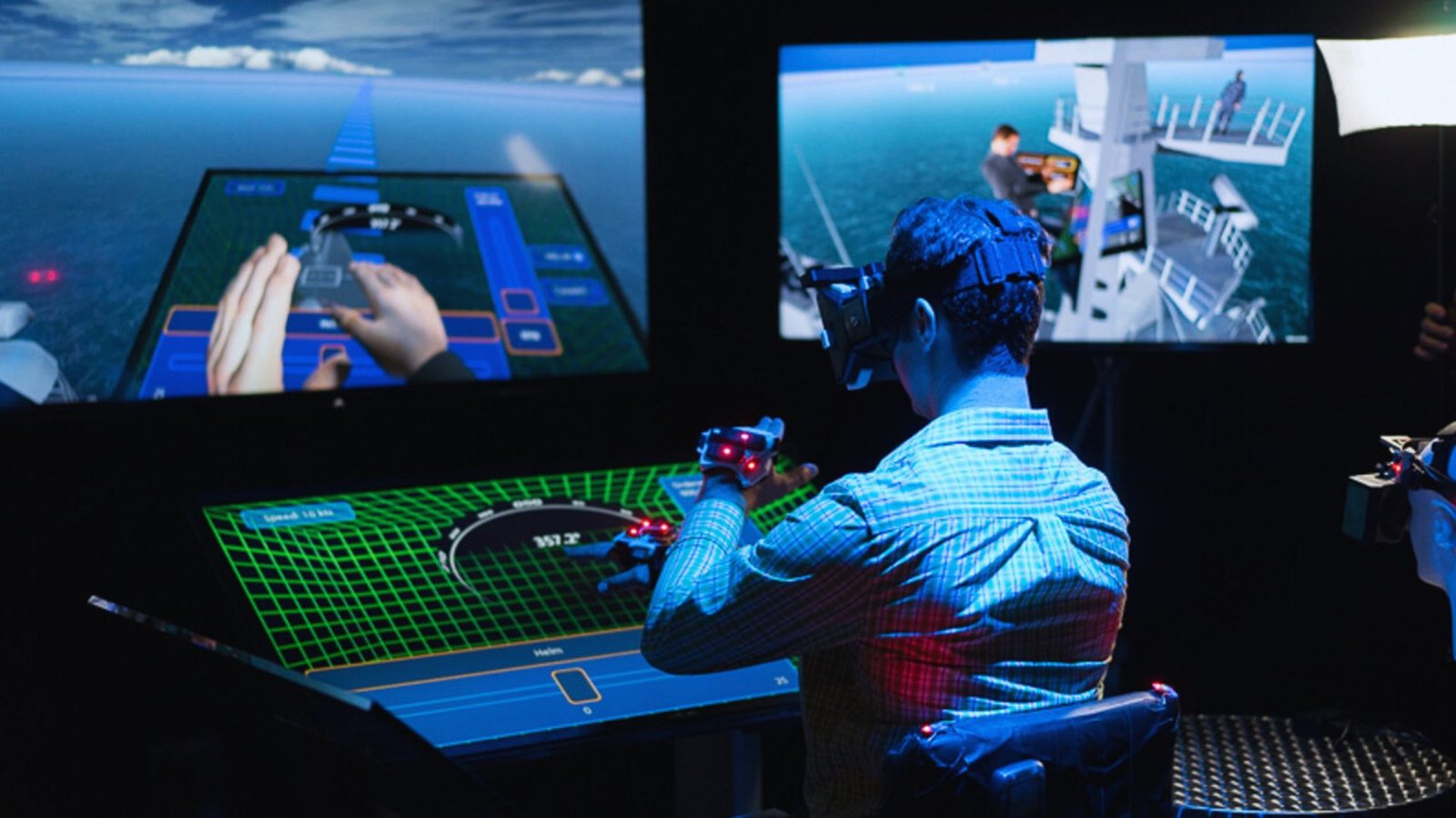  A man focused on playing a video game displayed on a large screen in a dimly lit room.