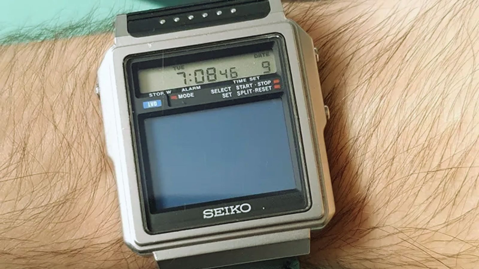 A man showcasing a Seiko watch on his wrist, highlighting its elegant design and craftsmanship.