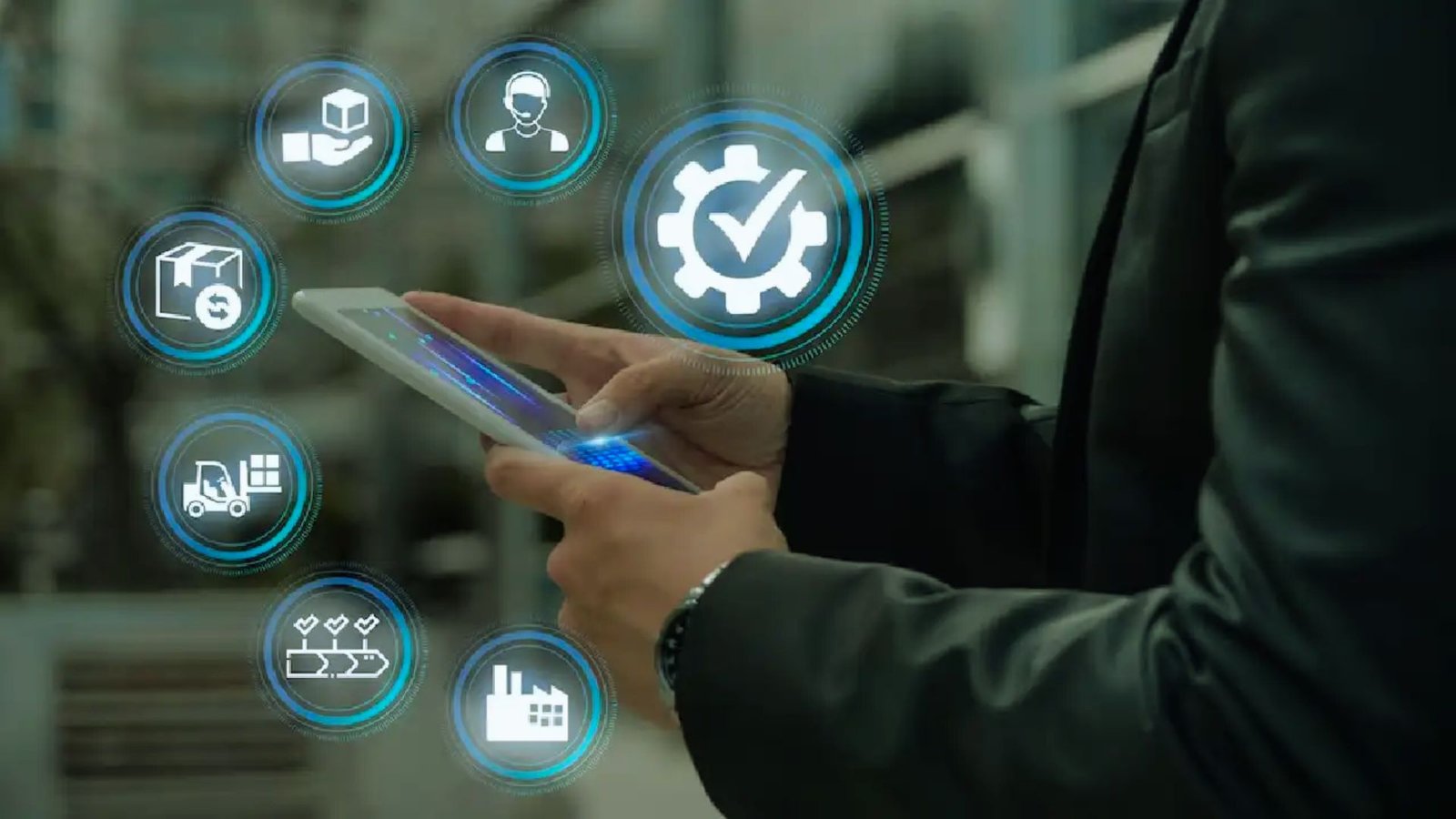 A man in a suit holds a tablet displaying various icons, suggesting a focus on technology or business applications.