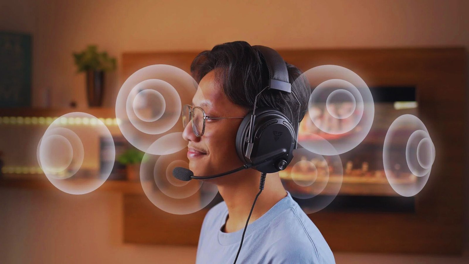  A man wearing headphones intently watches a television screen in a cozy living room setting.