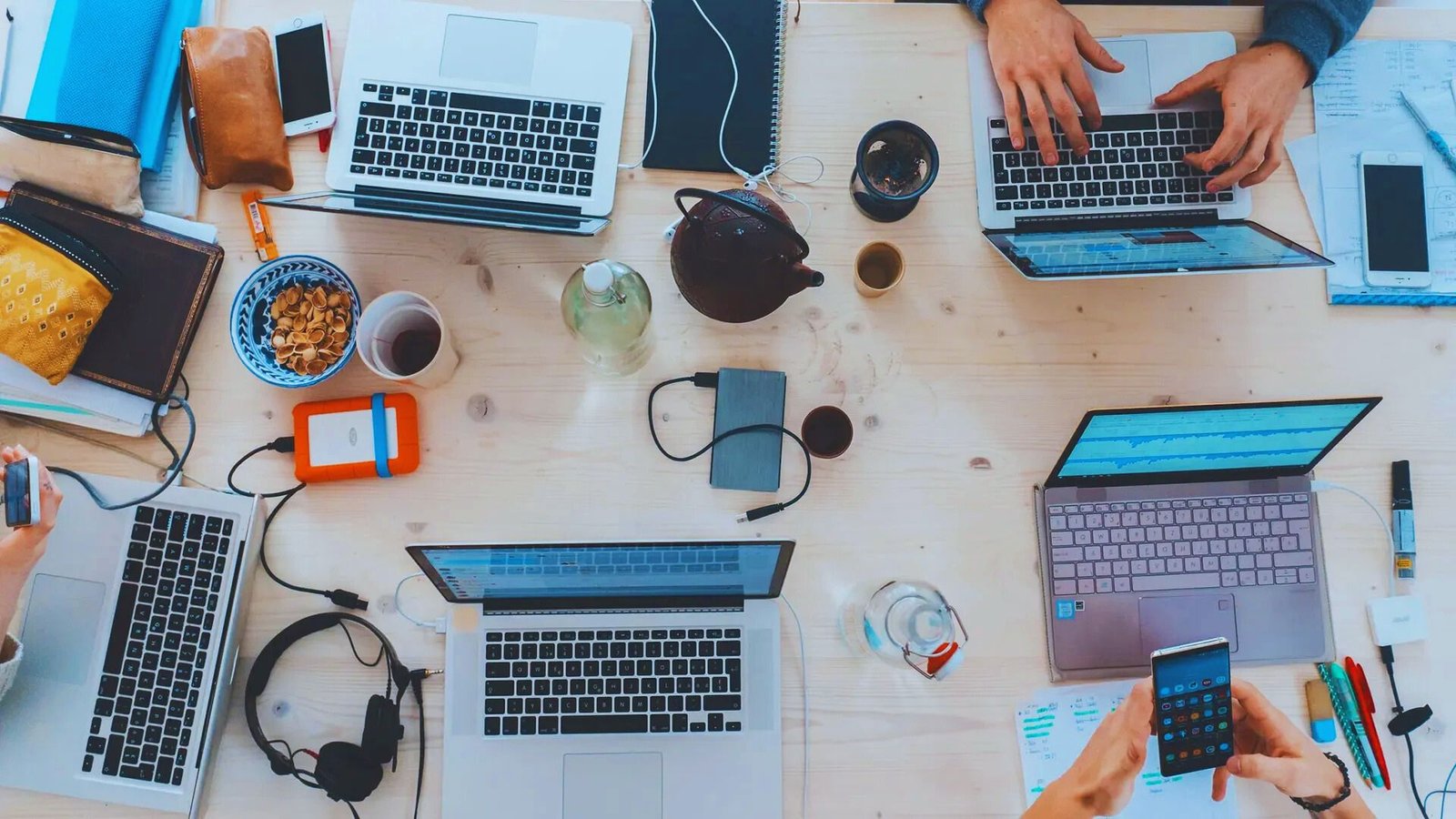 A man wearing a virtual reality headset points at a screen, engaged in an immersive digital experience.