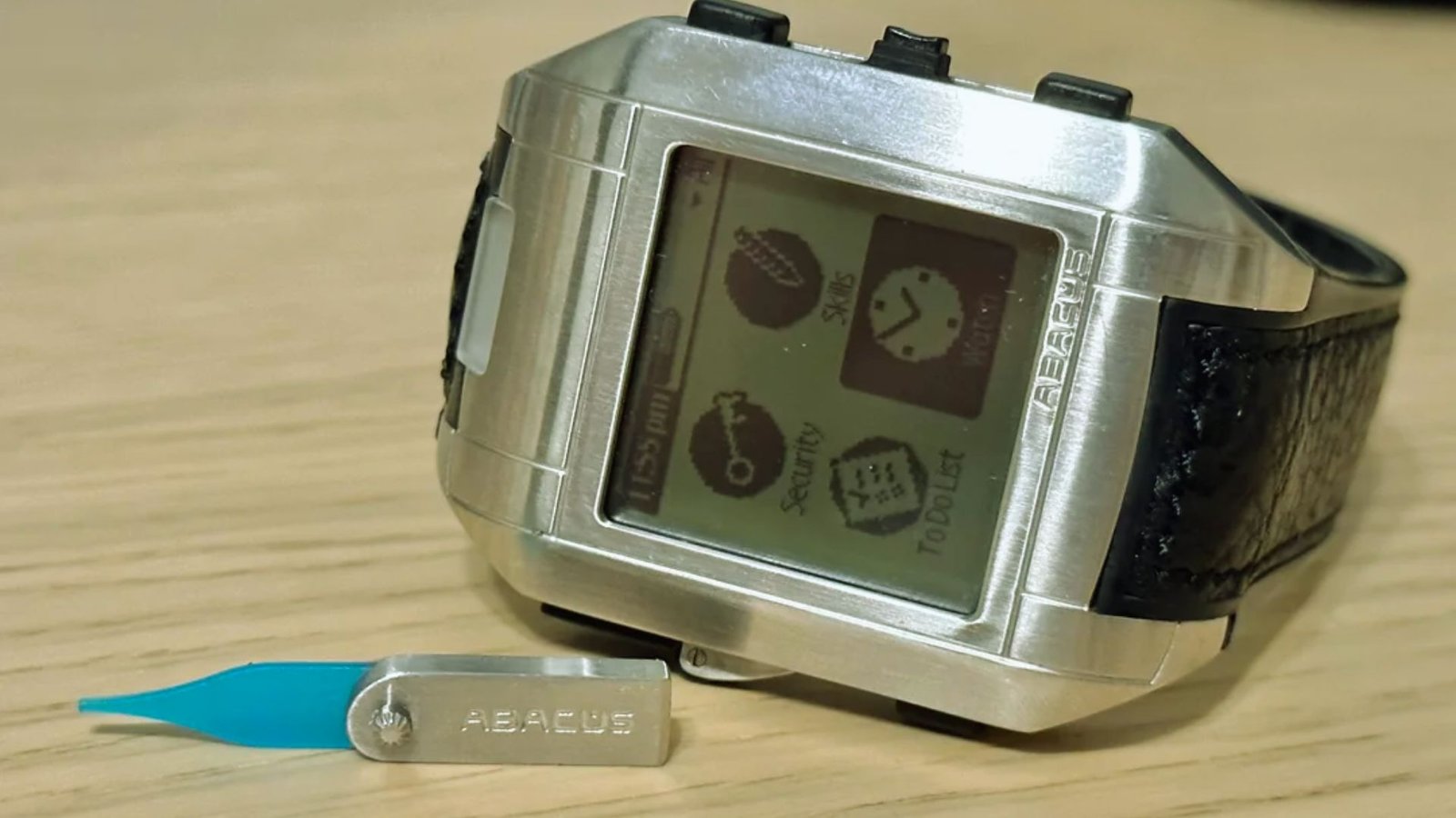 A silver watch featuring a blue tooth attachment, showcasing a modern design and technology integration.
