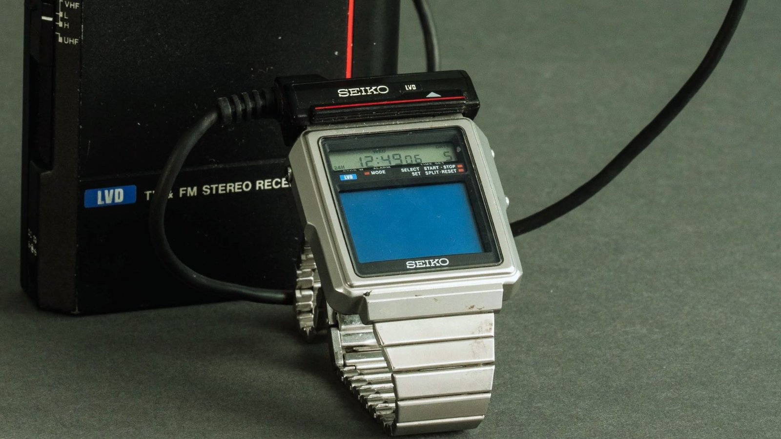A digital watch with a cord attached, displaying time and features for easy access and use.
