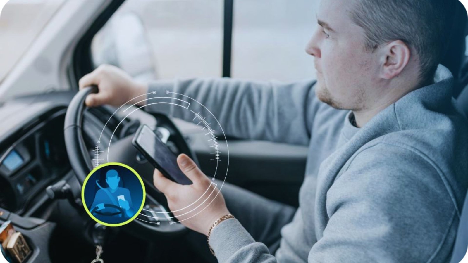 A man holds the steering wheel while driving a car, focused on the road ahead.