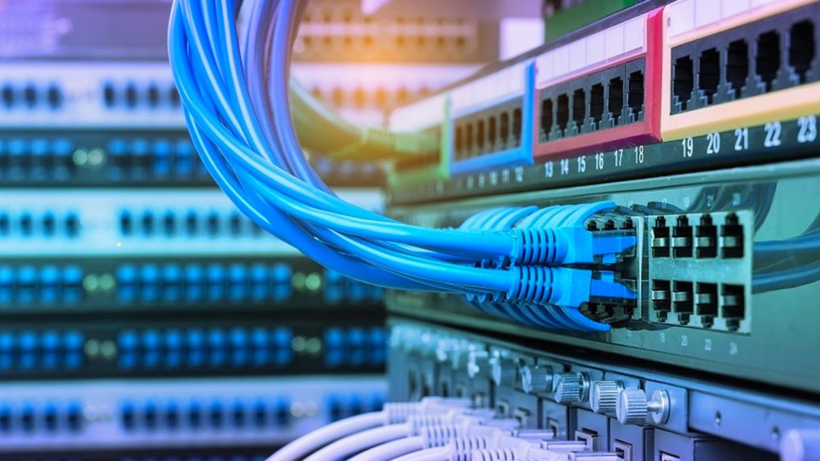  Close-up of a network switch with multiple colorful cables connected to various ports.