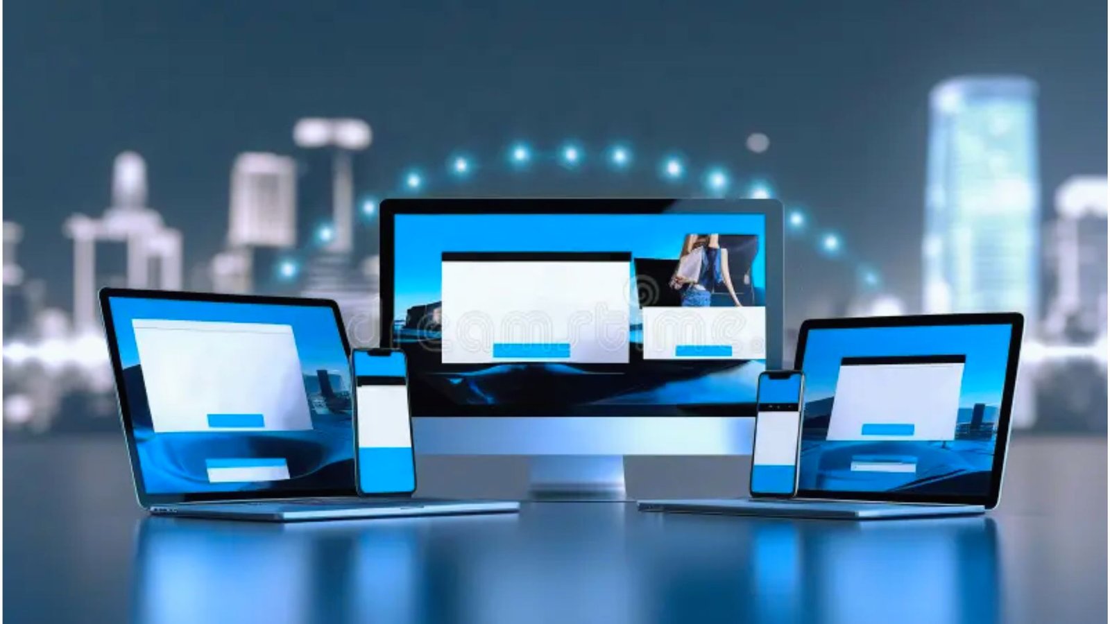  Three laptops and a monitor are displayed with a cityscape visible in the background.