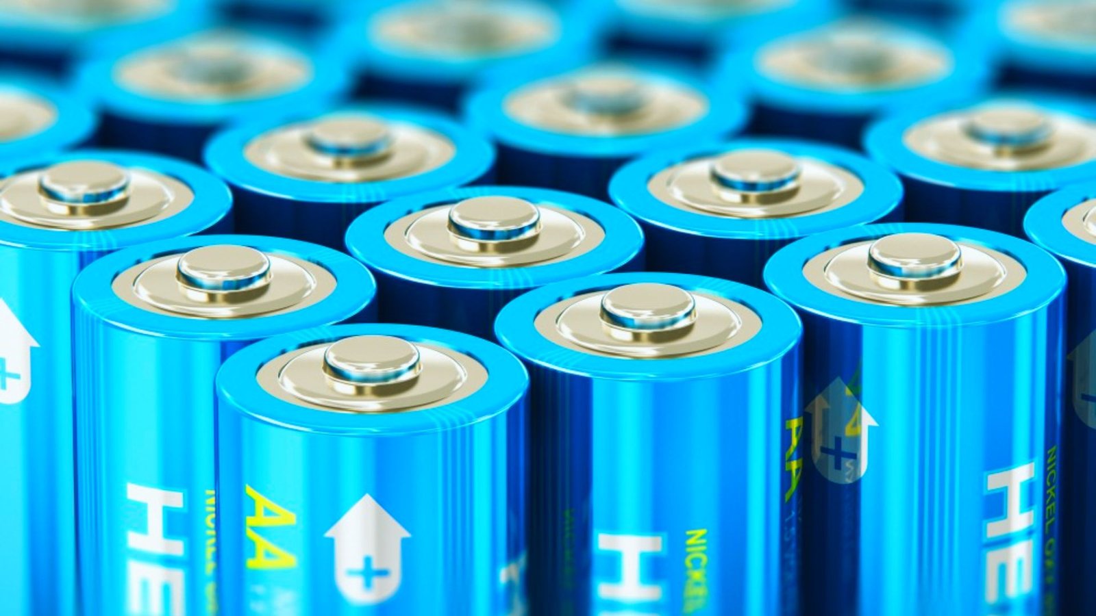  A large stack of blue batteries arranged closely together, showcasing their uniform color and cylindrical shape.

