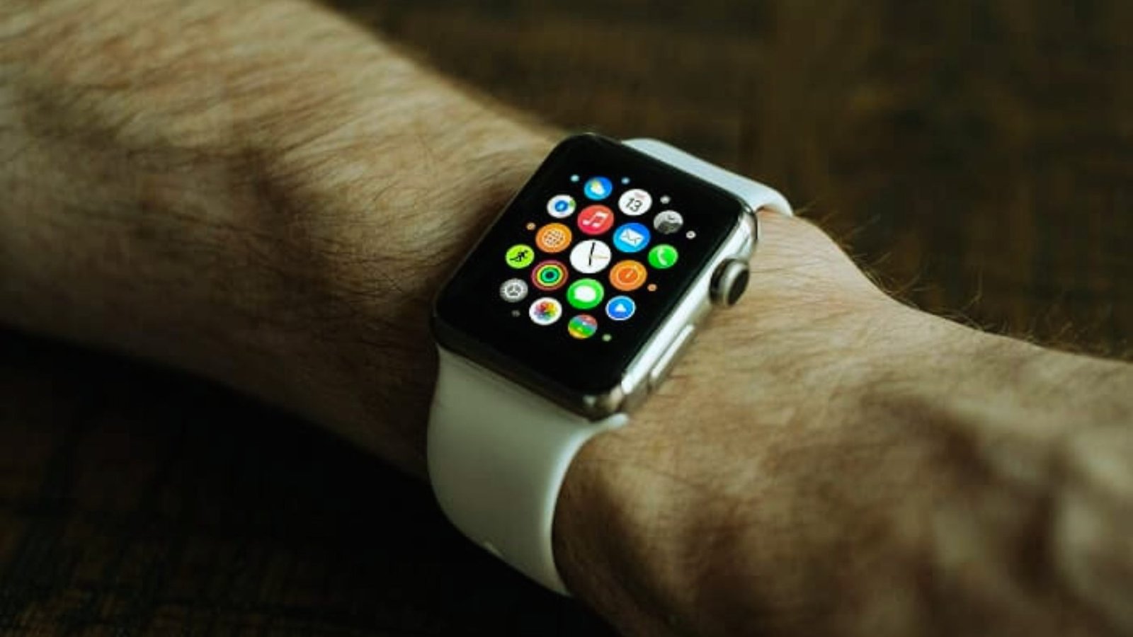 An Apple Watch displayed on a man's wrist, showcasing its sleek design and digital interface.